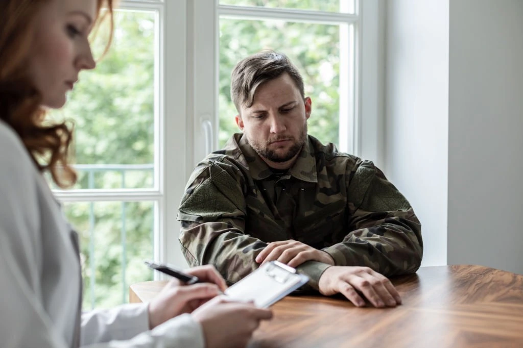 An Insurance agent assessing an Insurance form of a veteran